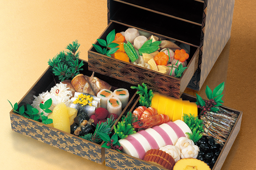 Osechi (traditional Japanese New Year cuisine) served in maki-e tiered lacquerware boxes