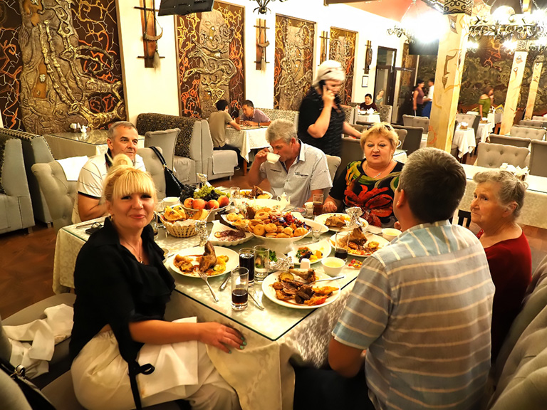 kyrgyz people around the table with family and friends